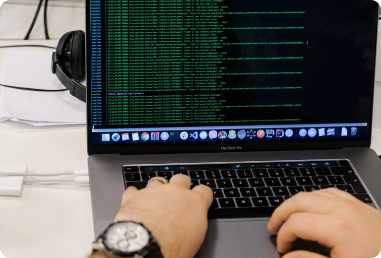 Kodius member working at his desk with a smile on his face