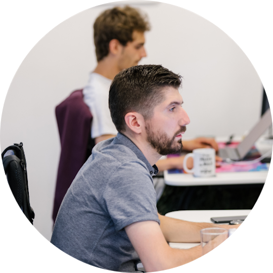 Step two image - Matija working on his laptop, at his work post